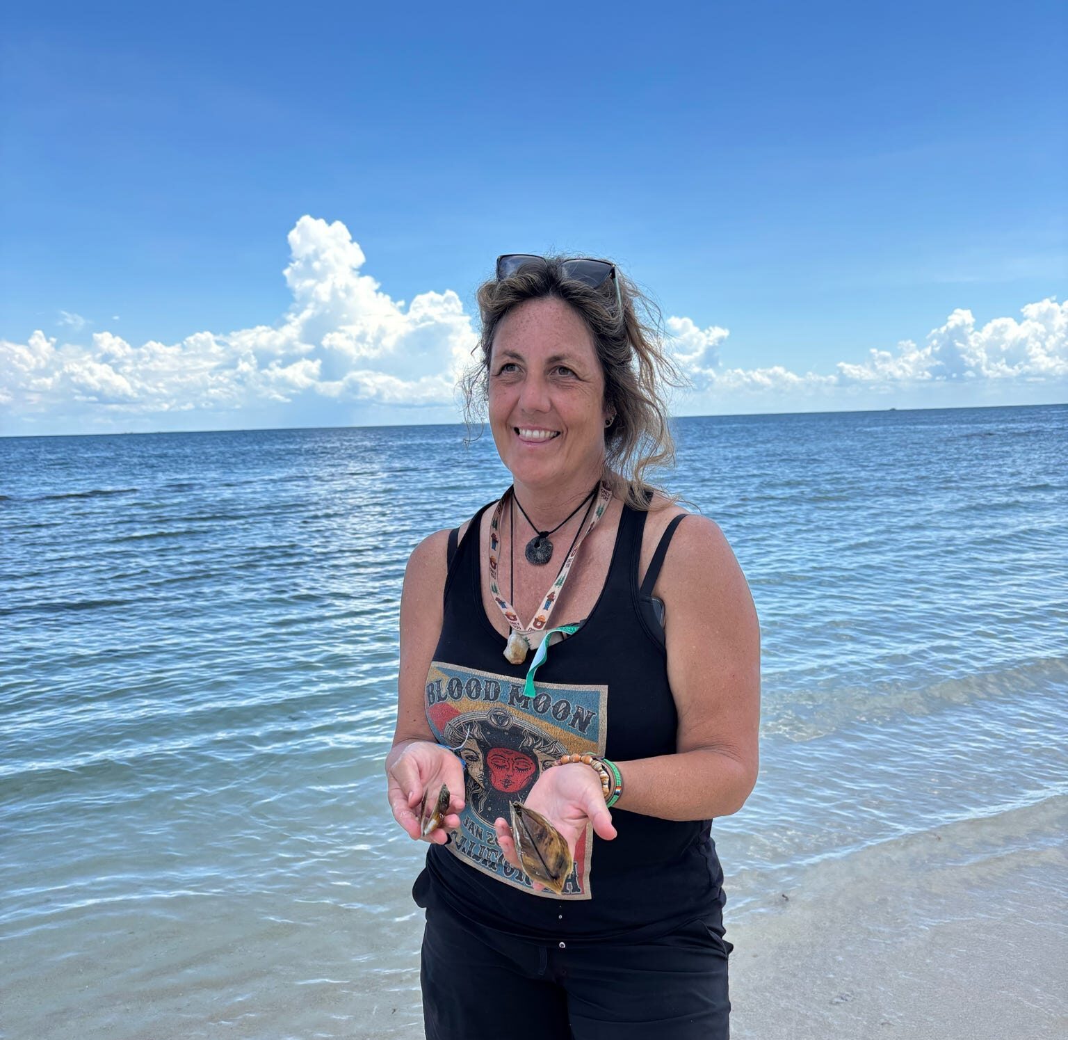 Traveller enjoying the clear Indian Ocean beside a white-sand Zanzibar beach